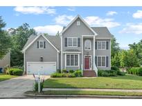 Charming two-story home with gray siding, manicured lawn, and mature landscaping at 1504 Haventree Rd, Durham, NC 27713