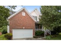 Charming two-story brick home featuring a two-car garage and a welcoming front porch at 1604 Carnation Dr, Durham, NC 27703