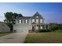 Charming two-story home with a two-car garage, landscaped yard, and covered front porch at 20 Sugarpine Trl, Clayton, NC 27520