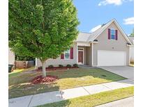 Charming home with a well-manicured lawn, tree, and neutral siding at 202 Verrazano Pl, Clayton, NC 27520