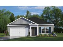 Charming one-story home featuring a gray exterior, a two-car garage, and a well-manicured front yard at 228 Palomino Way, Clayton, NC 27520