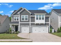 Charming two-story home featuring a two-car garage and beautifully landscaped front yard at 325 Buckhorn Branch Park, Clayton, NC 27520