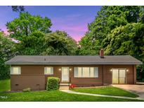 Charming ranch home with a well-maintained lawn and a cozy, inviting entrance at 330 Wilmot Dr, Raleigh, NC 27606