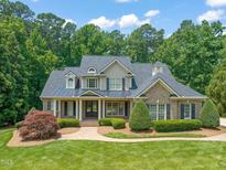Stately home boasts manicured lawn, lush landscaping, and a welcoming front porch, creating great curb appeal at 3728 Westbury Lake Dr, Raleigh, NC 27603
