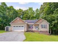 Charming single-story home with neutral siding, stone accents, and an attached two-car garage at 62 Mountain Laurel Ln, Four Oaks, NC 27524