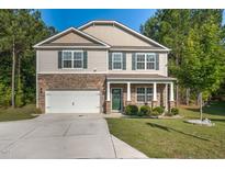 Charming two-story home featuring stone accents, a two-car garage, and a beautifully landscaped front yard at 98 Panmure, Rocky Mount, NC 27804