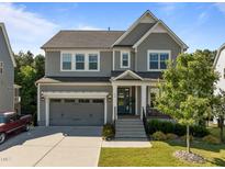 Charming two-story home showcasing neutral siding, an attached garage, and a welcoming front porch at 98 Stone Bridge Xing # 98, Chapel Hill, NC 27517