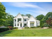 Stunning two-story home featuring a landscaped front yard and a blend of white brick and gray siding at 109 Greenock Ct, Cary, NC 27511