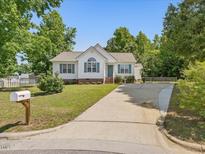 Charming home with a well-manicured lawn and a long driveway at 1230 Piney Glen Ln, Zebulon, NC 27597