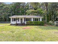 Charming one-story home with a well-maintained lawn, mature trees, and curb appeal at 141 Weston Rd, Garner, NC 27529