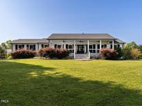 Charming single-story home with lush lawn and inviting front porch, perfect for relaxing outdoors at 1625 Haystack Ln, Burlington, NC 27217