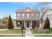 Charming two-story home with inviting front porch and manicured lawn at 2122 Aventon Ln, Morrisville, NC 27560
