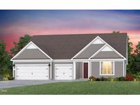 Charming single-Gathering home with a three-car garage, beautiful lawn, and inviting front entrance at 2516 Del Webb Gardens Dr, Fuquay Varina, NC 27526