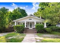 Charming home featuring a welcoming front porch, classic architectural details, and a well-maintained lawn at 306 Union Ave, Burlington, NC 27217