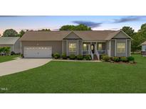 Charming single-story home featuring a well-manicured lawn and an attached two-car garage at 402 S Wilma St, Angier, NC 27501