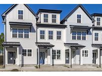Charming new construction townhomes showcasing unique architectural detail, curb appeal, and inviting front entrances at 4821 Gossamer Ln # 102, Raleigh, NC 27616