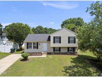 Charming split-level home featuring a well-maintained lawn and classic black shutters at 5529 Wood Pond Ct, Raleigh, NC 27610