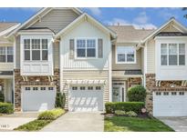 Attractive townhome with a one car garage and inviting landscaping at 5936 Hourglass Ct, Raleigh, NC 27612