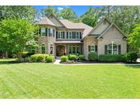 Charming two-story home with a well-manicured lawn and beautiful landscaping at 7552 Hasentree Club Dr, Wake Forest, NC 27587