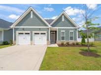 Charming home featuring a two-car garage, manicured lawn, and tasteful landscaping at 797 S Wilma St, Angier, NC 27501