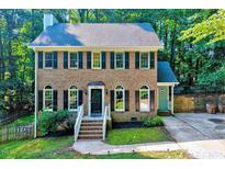 Charming brick home with symmetrical windows, black shutters, and manicured front yard at 838 Joyner Ct, Wake Forest, NC 27587