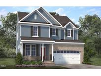 Charming two-story home boasts a brick-accented garage and inviting front porch at Lot 53 Magnolia Acres Ln, Fuquay Varina, NC 27526