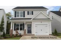Charming two-story home featuring a well-manicured lawn and a cozy front porch at 103 Goldenrod Loop, Clayton, NC 27520