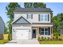 Charming two-story home with gray siding, a garage, and professionally landscaped yard at 103 Goldenrod Loop, Clayton, NC 27520