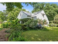 Charming home with a white exterior and beautiful landscaping with lots of curb appeal at 1090 S Fifth St, Mebane, NC 27302