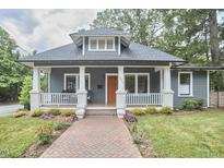 Charming craftsman home featuring a welcoming front porch and beautifully landscaped front yard at 2031 Englewood Ave, Durham, NC 27705