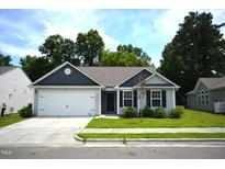 Charming single-story home with a two-car garage, manicured lawn, and inviting curb appeal at 2039 Alderman Way, Creedmoor, NC 27522