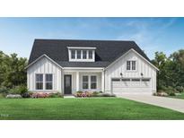 Charming one-story home showcasing a modern farmhouse design with white siding and a well-manicured lawn at 2309 Abbeyhill Dr # 2, Raleigh, NC 27610
