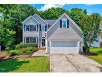 Charming two-story home with manicured lawn, attached two-car garage, and well-maintained landscaping at 2501 Springfield Park Dr, Raleigh, NC 27614