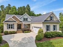Inviting single-Gathering home featuring a landscaped front yard and attached two-car garage, complemented by stylish stone accents at 259 Brown Bear, Chapel Hill, NC 27517