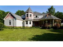 Unique home with a turret, covered porch, and multiple roof lines at 2816 Shepard School Rd, Zebulon, NC 27597
