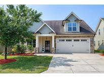 Charming home with a two-car garage, stone accents, and a well-manicured lawn at 29 Laurel Ln, Youngsville, NC 27596