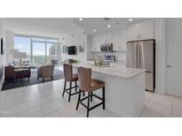 Modern kitchen with white cabinets, stainless appliances and granite counters at 301 Fayetteville St # 2611, Raleigh, NC 27601