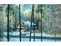 Charming home exterior featuring stone accents and a snowy landscape at 3587 Garner Terrace Way, Wake Forest, NC 27587
