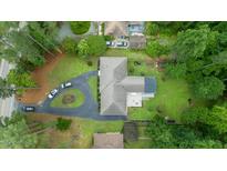 Stunning aerial view of a home featuring a circular driveway, lush landscaping, and a well-maintained roof at 3934 Hope Valley Rd, Durham, NC 27707