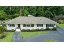 Charming ranch-style home with manicured landscaping, blacktop drive, and inviting curb appeal at 3934 Hope Valley Rd, Durham, NC 27707