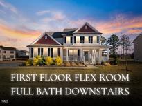 Charming two-story home featuring classic architectural details and a beautifully landscaped front yard, creating a welcoming curb appeal at 46 Two Belles Ct, Angier, NC 27501
