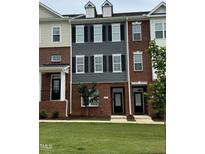 Traditional brick townhome featuring black shutters and manicured lawn at 503 Gateway Townes Blvd, Wake Forest, NC 27587