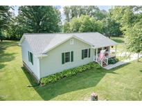 Charming ranch home features a covered porch, green shutters, and mature landscaping at 523 Edwards Rd, Henderson, NC 27537