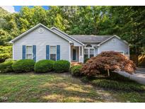 Charming home featuring tidy landscaping, blue shutters, and a well-maintained yard at 5405 Swordsman Ct, Knightdale, NC 27545
