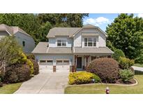 Charming two-story home with a two car garage, inviting front porch, and beautifully landscaped front yard at 5545 Moneta Ln, Apex, NC 27539