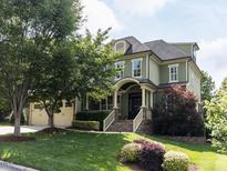 Charming two-story home with a manicured lawn, attached two car garage, and lovely landscaping at 612 Peach Orchard Pl, Cary, NC 27519
