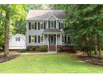 Two-story home with gray siding, black shutters, and a well-manicured lawn at 7604 Copper Creek Ct, Wake Forest, NC 27587