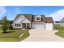 Charming single-Gathering home featuring a manicured lawn, and an attached two-car garage at 80 Shallow Falls Ln, Benson, NC 27504