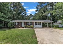 Charming single-story home with brick and white siding, and an inviting carport at 804 Colonial Dr, Raleigh, NC 27603