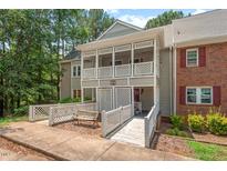 Charming condo boasts dual balconies, a ramp, and an inviting outdoor bench at 106 Choptank Ct # B-2, Cary, NC 27513